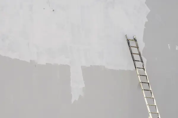Exterior painting in Oxnard: ladder against a freshly primed wall